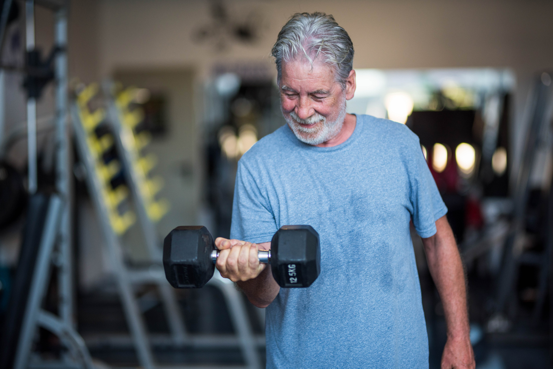 Elderly Man Working Out at the Gym