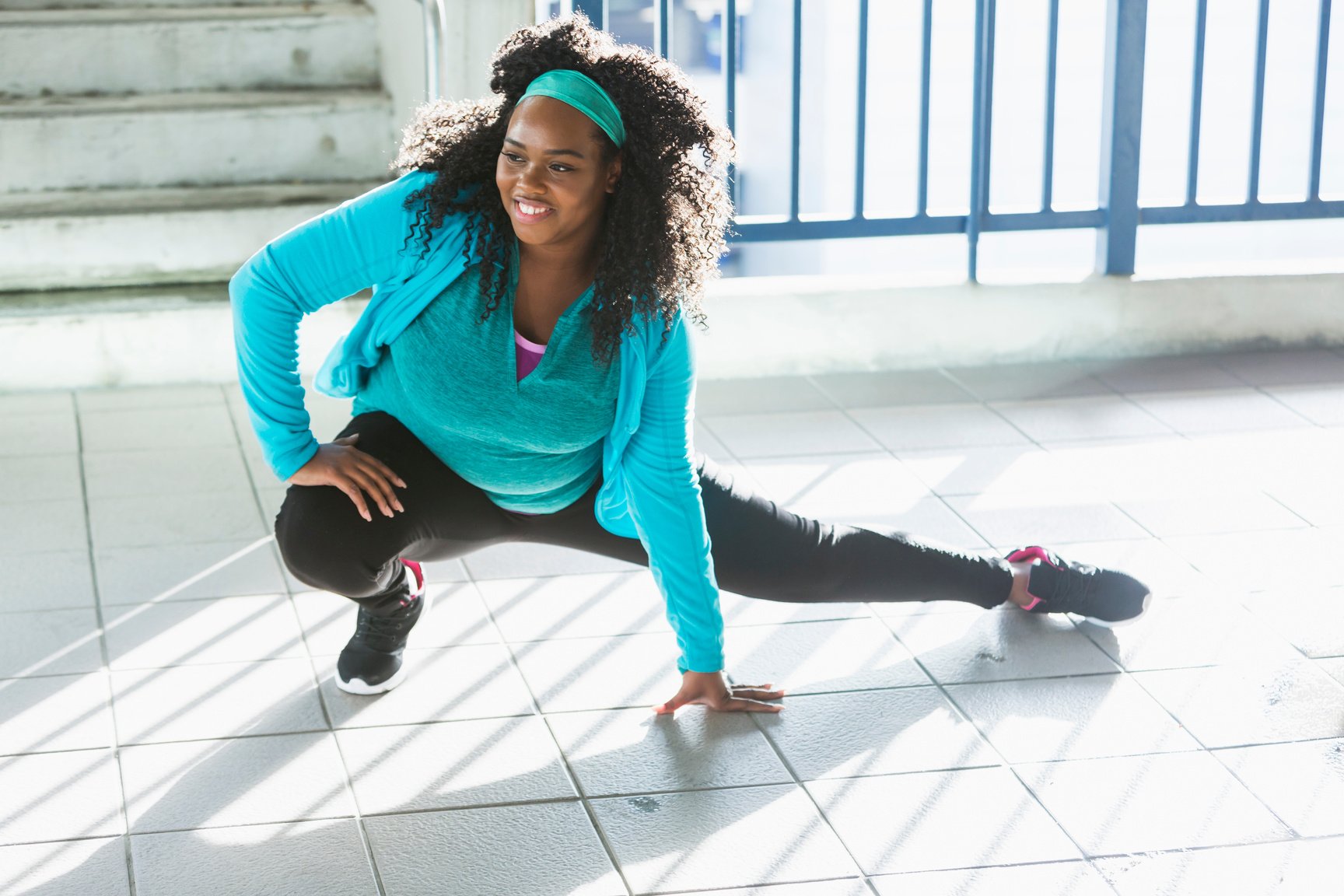 Confident young black woman exercising